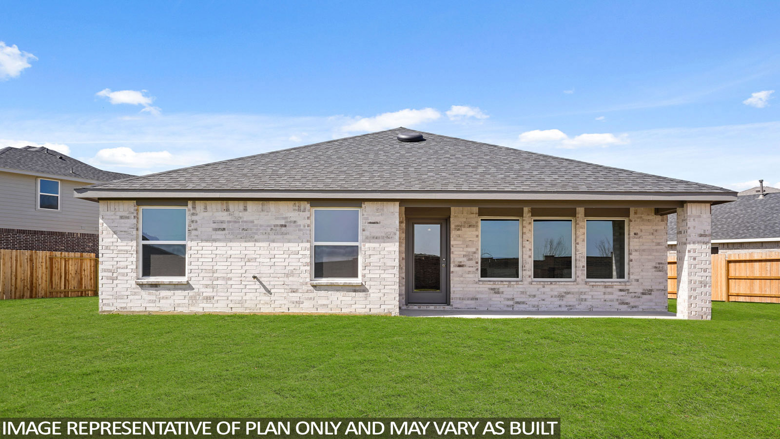 Landscaped backyard with a covered patio.