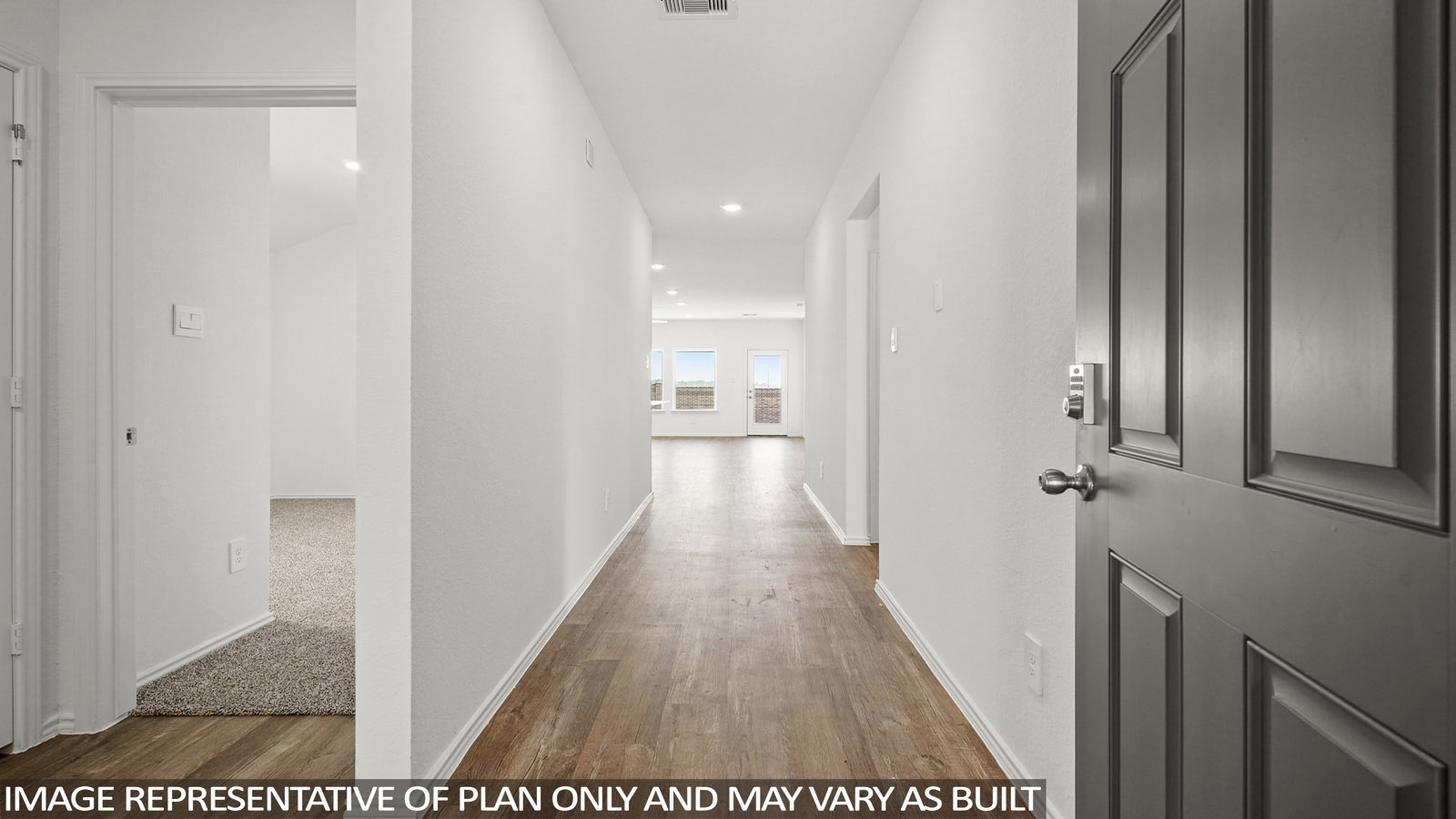 Entry hallway with white walls and vinyl wood flooring.