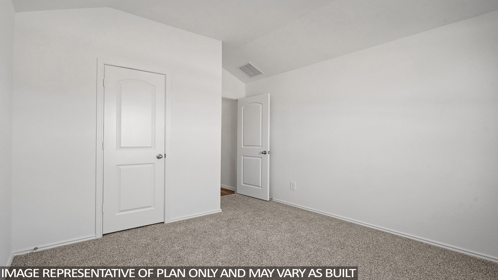 Secondary bedroom with windows, white walls, and light carpet.