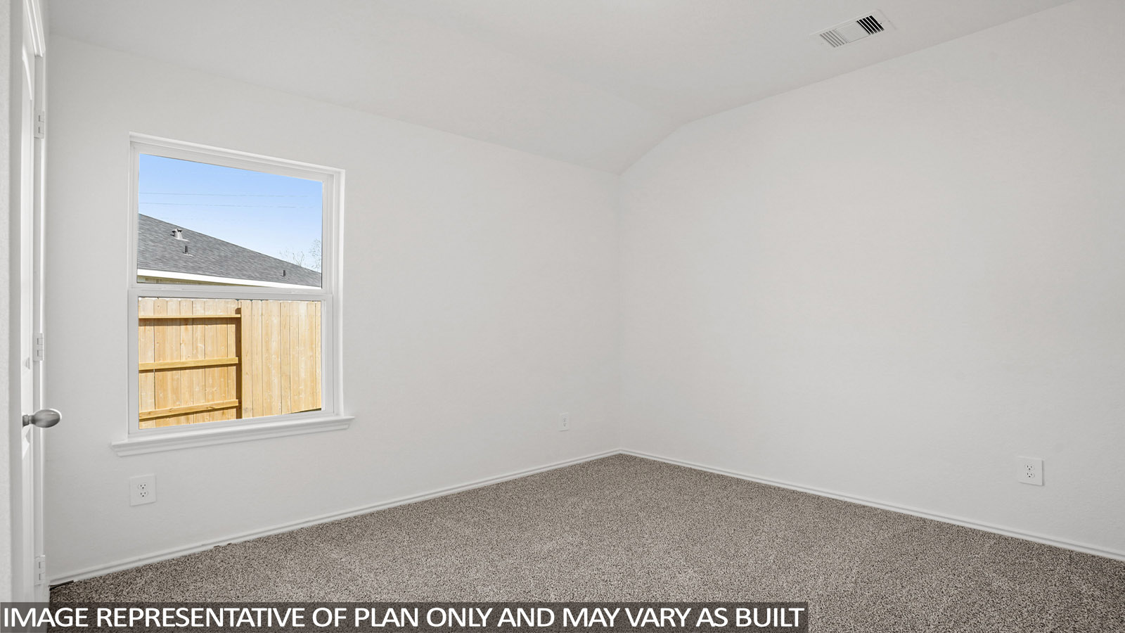 Secondary bedroom with windows, white walls, and light carpet.