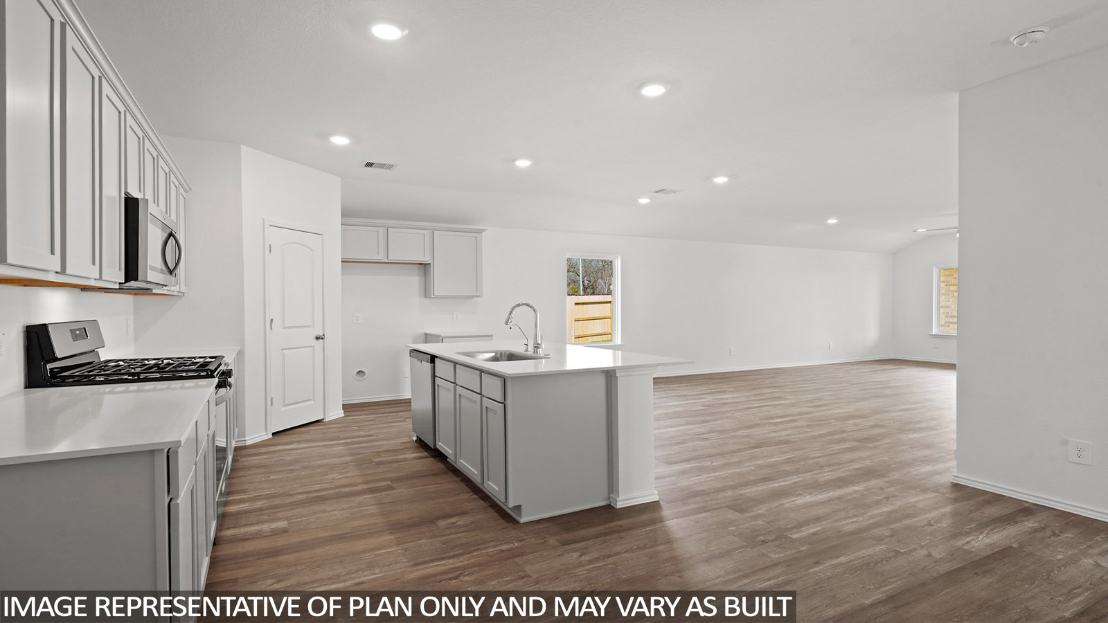 Open kitchen with an island, stainless steel appliances, white cabinets, white walls, and vinyl wood flooring.