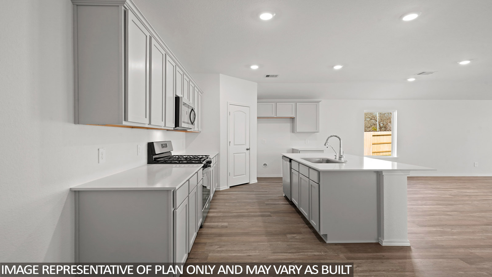 Open kitchen with an island, stainless steel appliances, white cabinets, white walls, and vinyl wood flooring.
