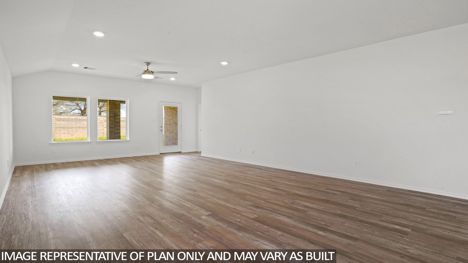 Open living room with windows, white walls, and vinyl wood flooring.