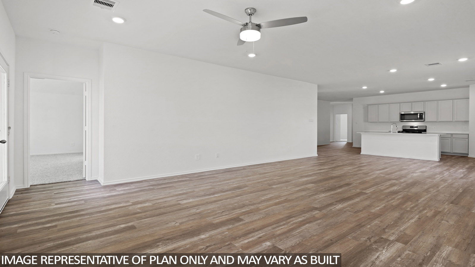 Open living room with windows, white walls, and vinyl wood flooring.