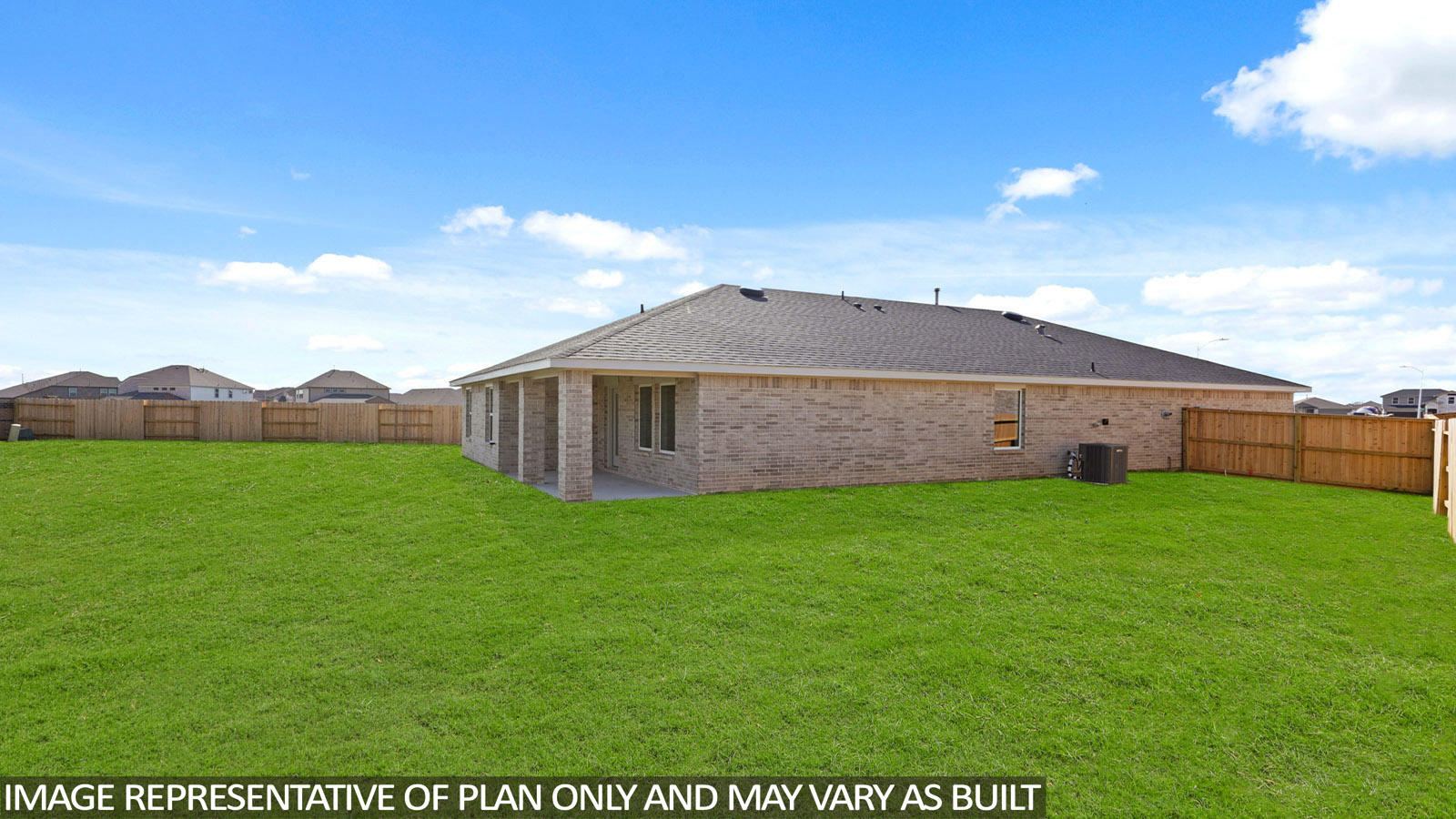 Landscaped backyard with a covered patio.