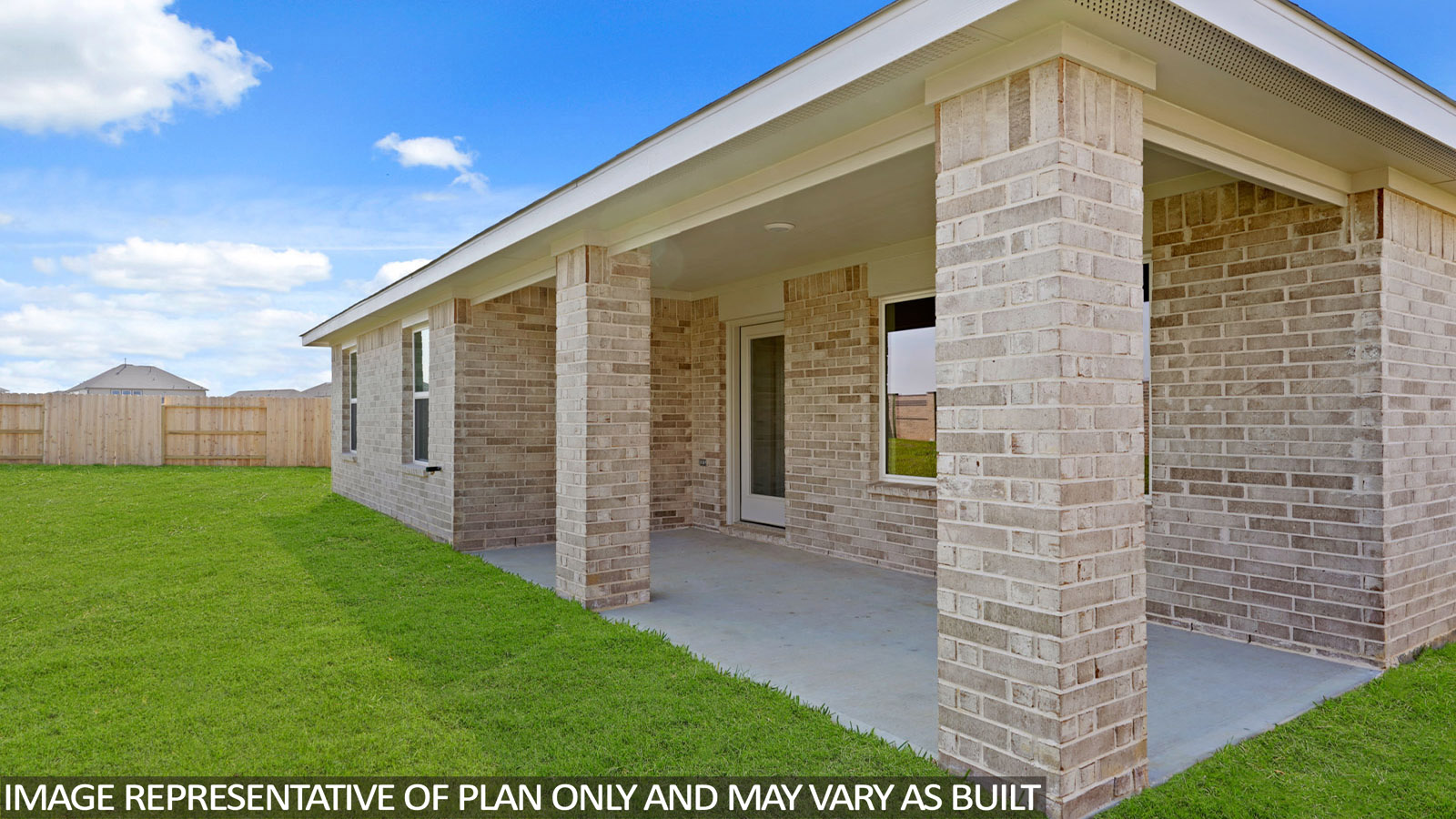 Landscaped backyard with a covered patio.