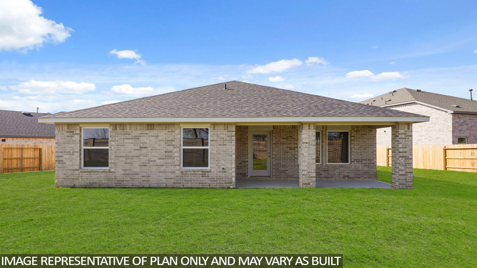 Landscaped backyard with a covered patio.