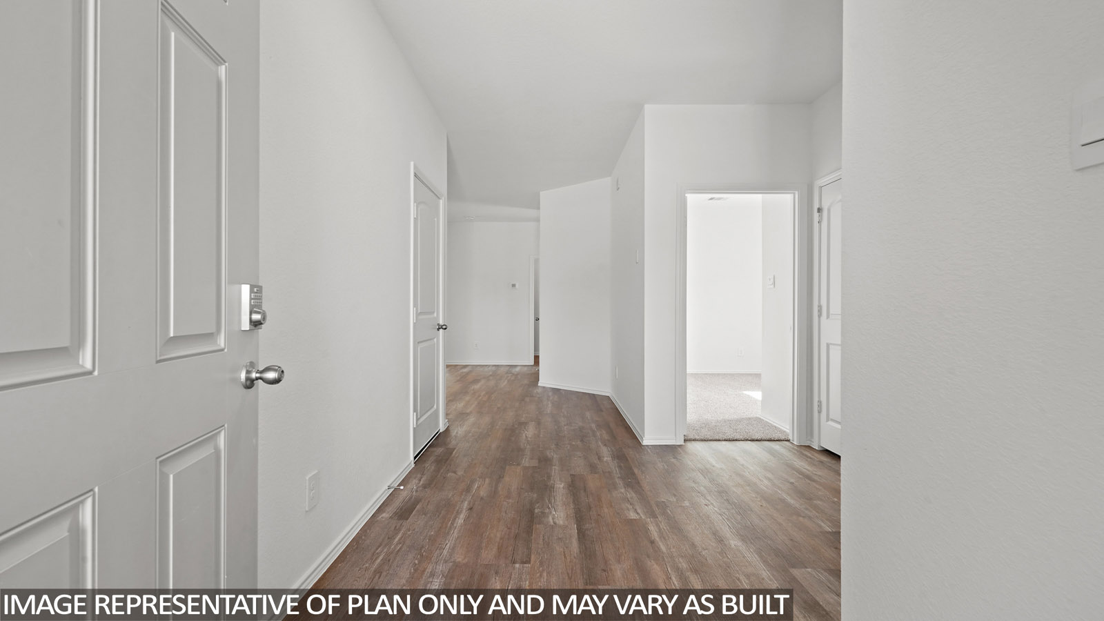 Entry hallway with white walls and vinyl wood flooring.
