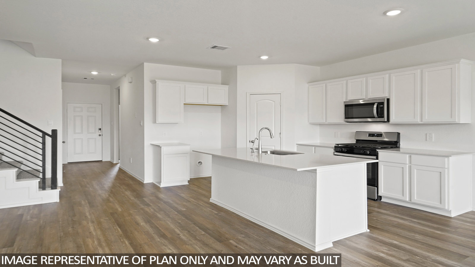 Open kitchen with an island, stainless steel appliances, white cabinets, white walls, and vinyl wood flooring.