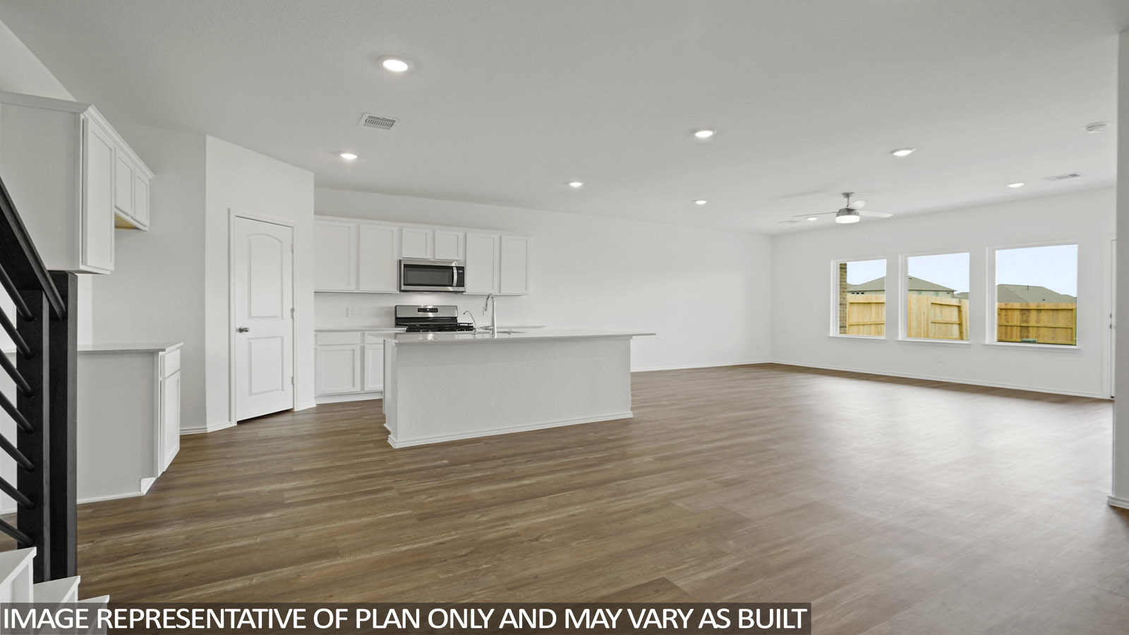 Open living room with windows, white walls, and vinyl wood flooring.