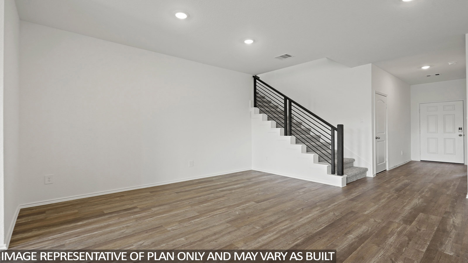 Open living room with windows, white walls, and vinyl wood flooring.