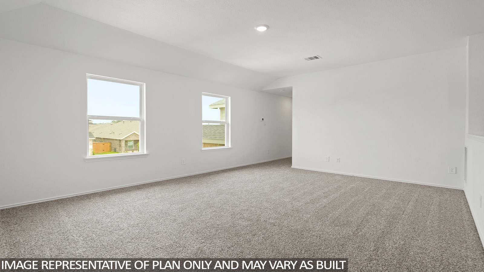 Large game room with windows, white walls, and light carpet.