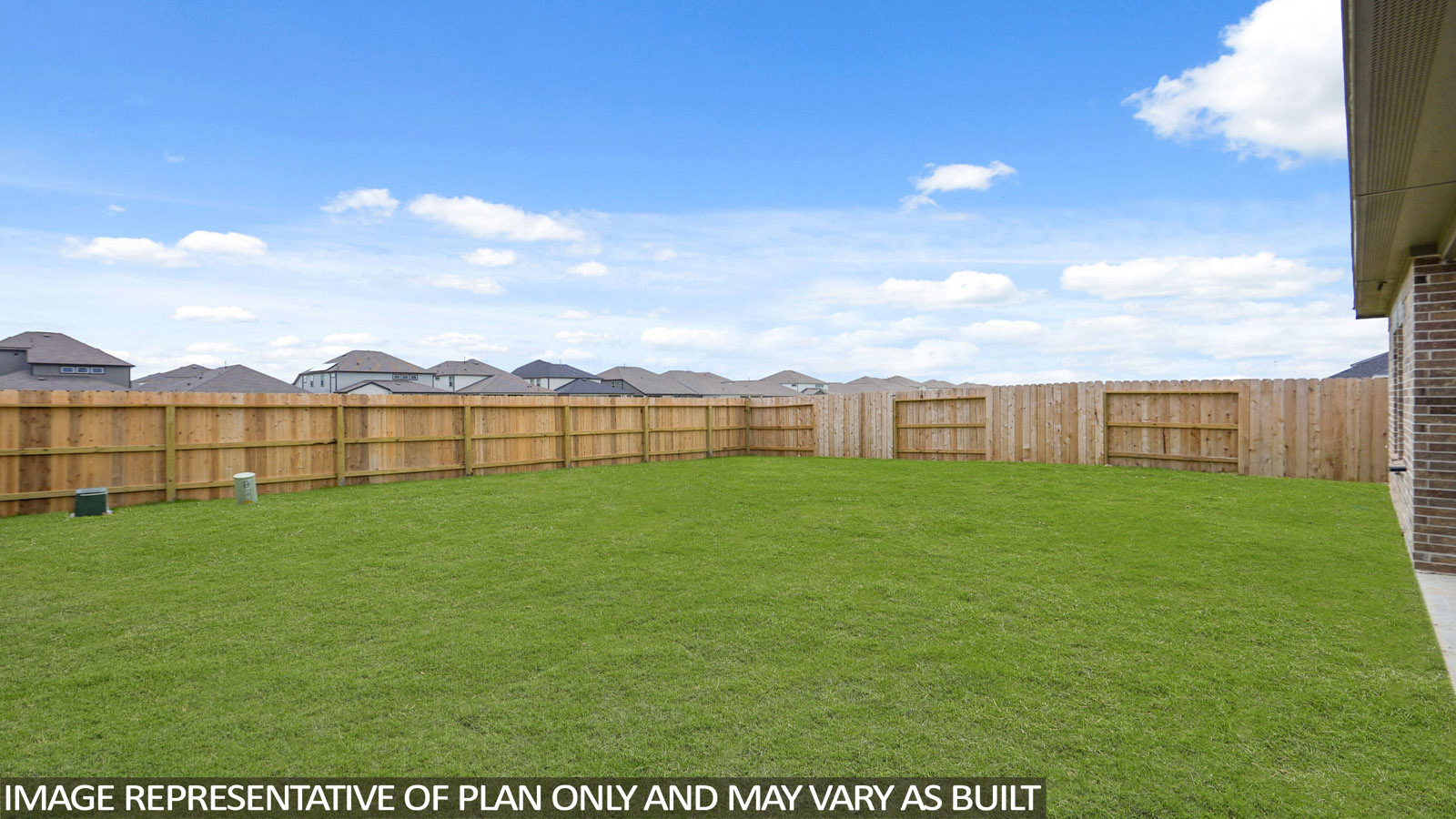 Landscaped backyard with a covered patio.