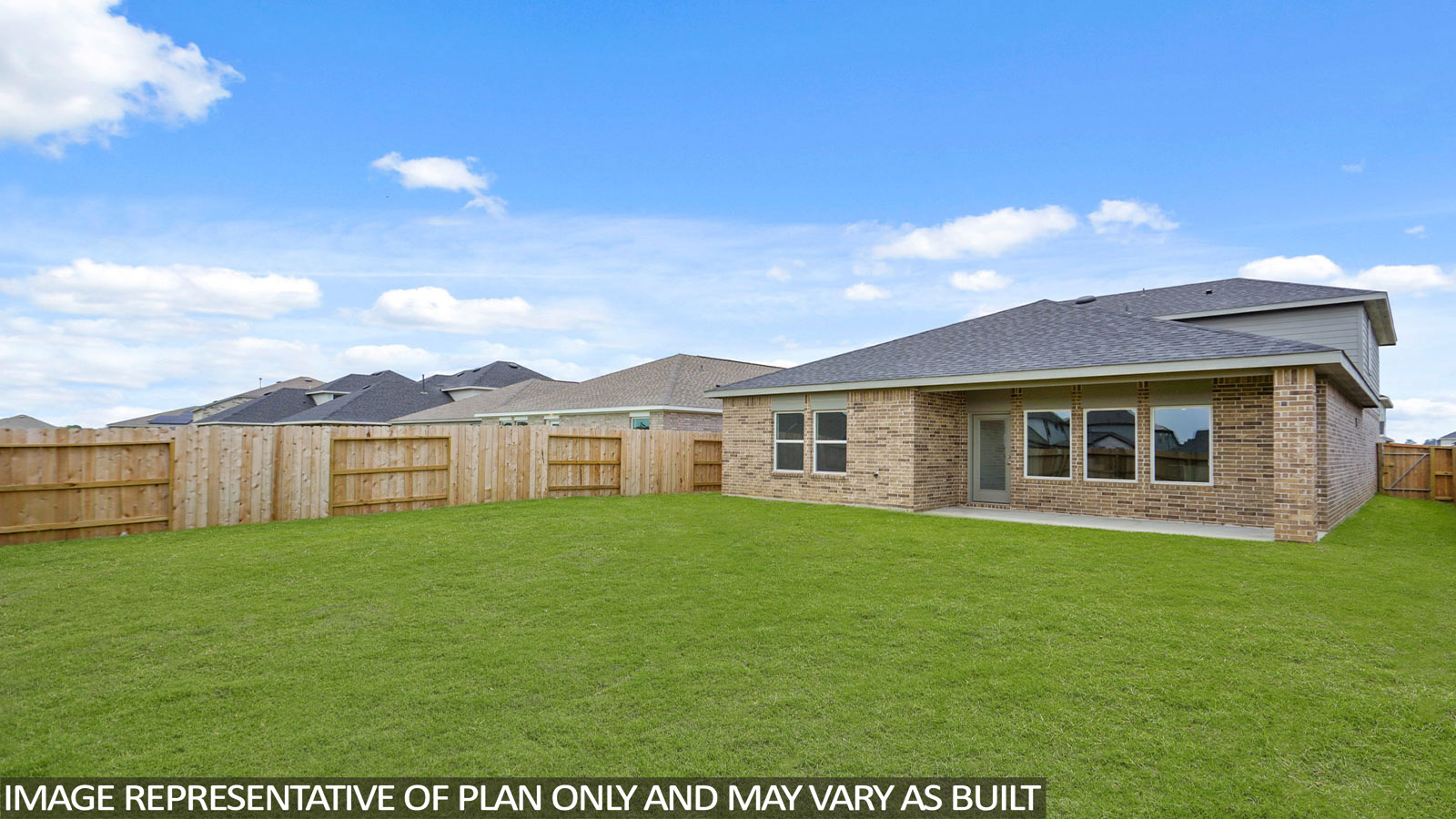 Landscaped backyard with a covered patio.
