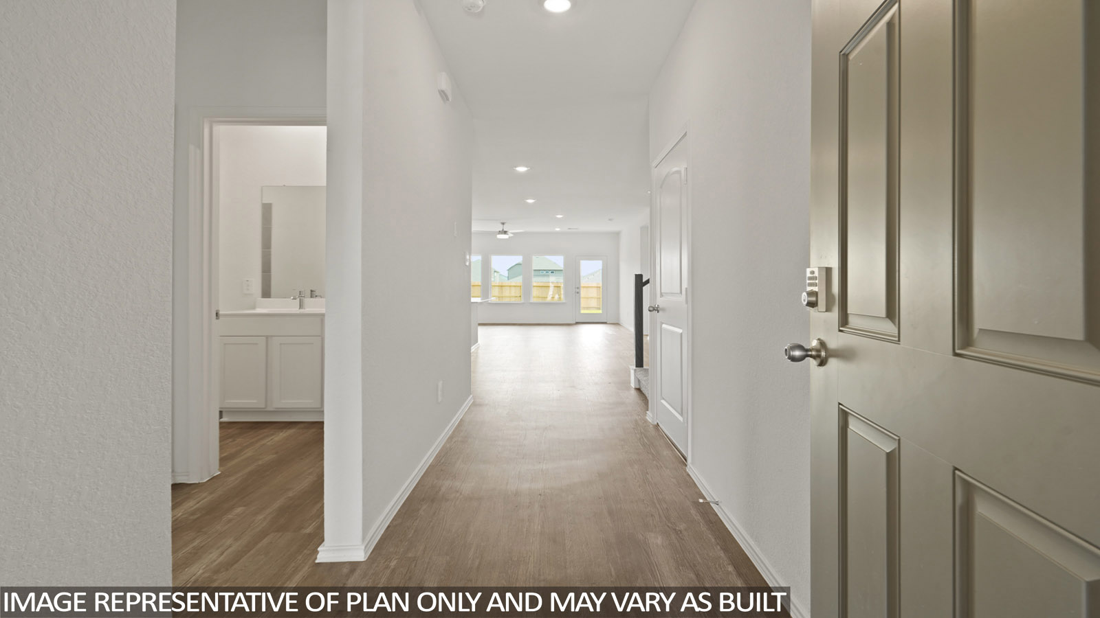 Entry hallway with white walls and vinyl wood flooring.