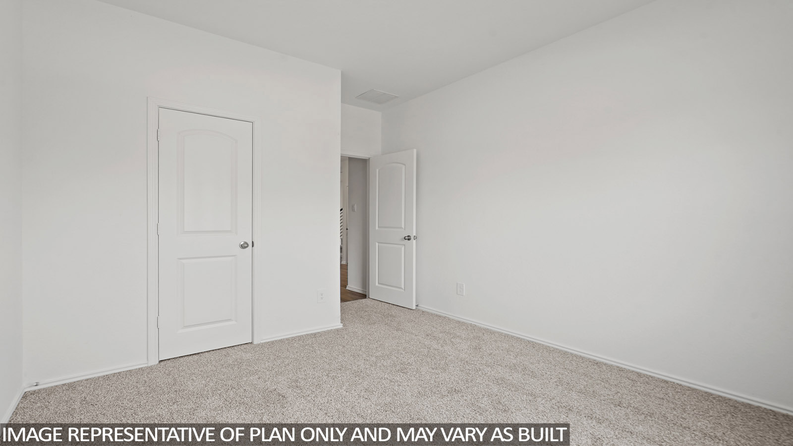 Secondary bedroom with windows, white walls, and light carpet.