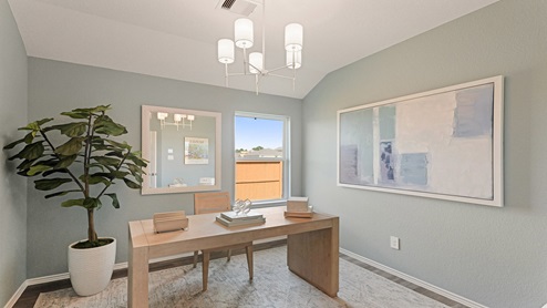 Study with windows, white walls, and vinyl wood flooring.