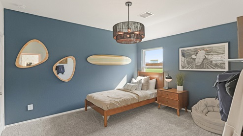 Secondary bedroom with windows, white walls, and light carpet.
