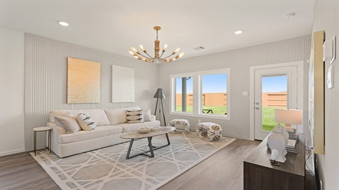 Open living room with windows, white walls, and vinyl wood flooring.
