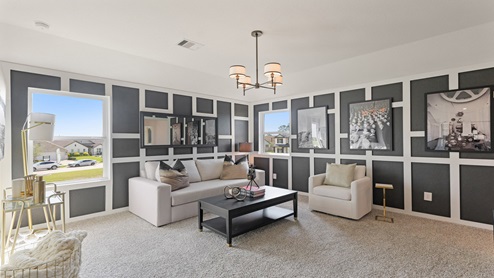 Large game room with windows, white walls, and light carpet.