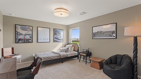 Secondary bedroom with windows, white walls, and light carpet.