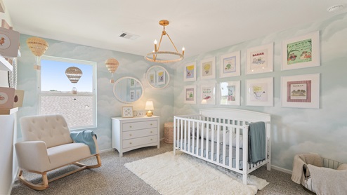 Secondary bedroom with windows, white walls, and light carpet.