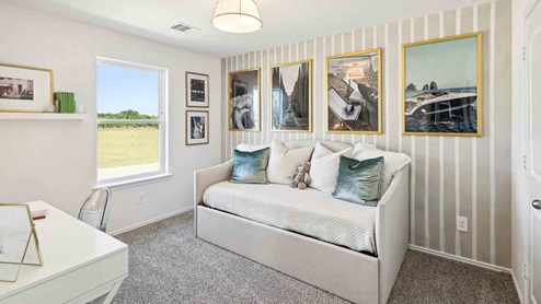 Secondary bedroom with windows, white walls, and light carpet.