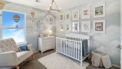 Secondary bedroom with windows, white walls, and light carpet.