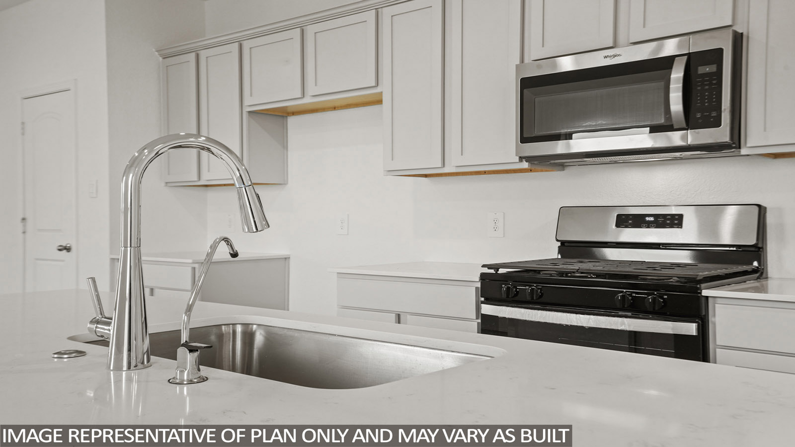 Open kitchen with an island, stainless steel appliances, white cabinets, white walls, and vinyl wood flooring.