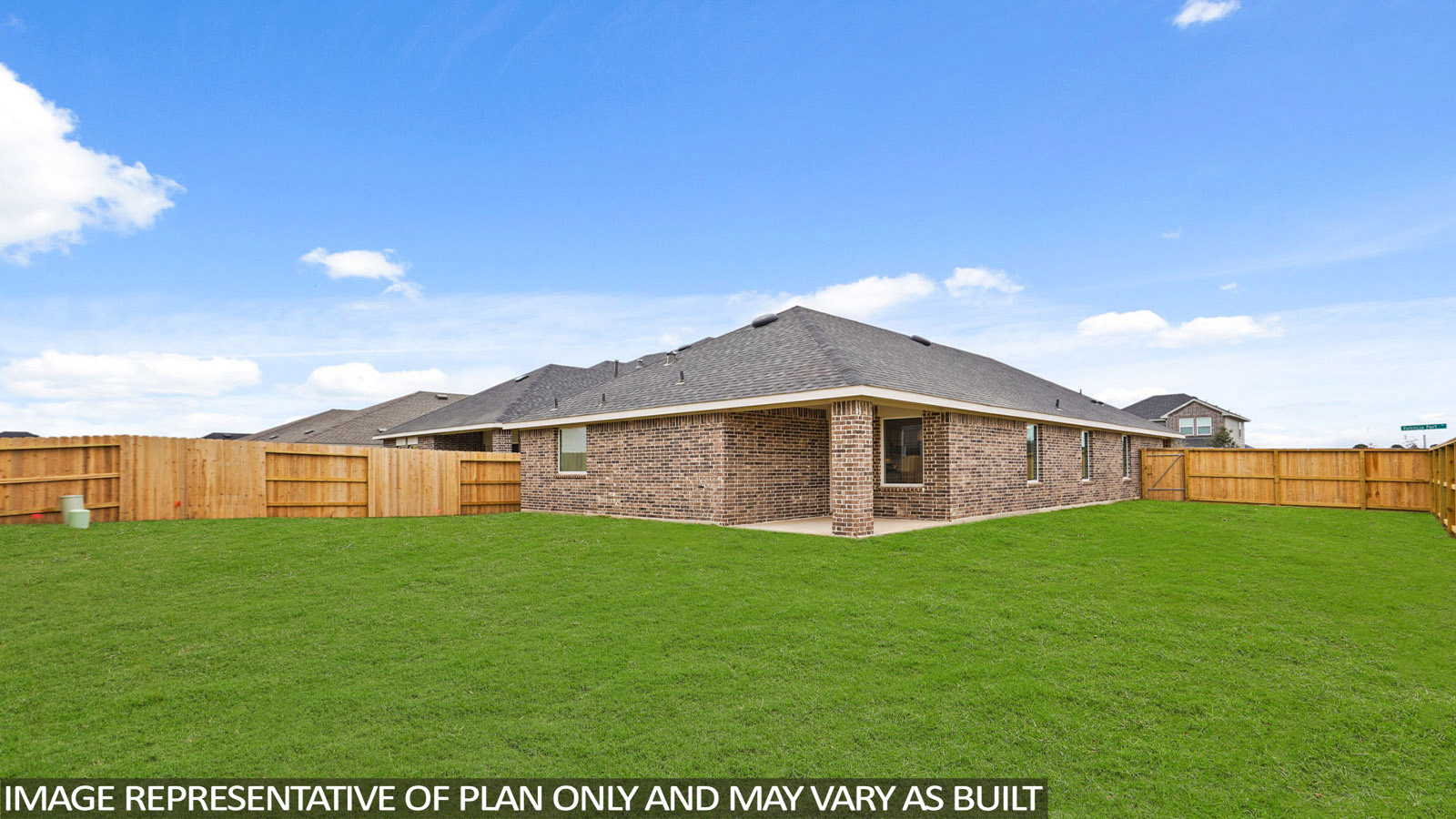 Landscaped backyard with a covered patio.