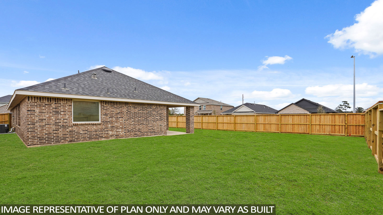 Landscaped backyard with a covered patio.