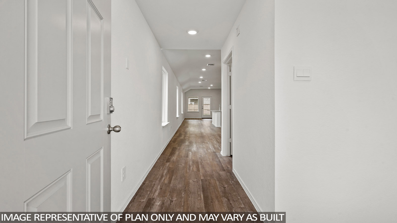 Entry hallway with white walls and vinyl wood flooring.