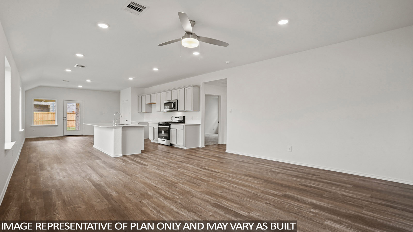 Open living room with windows, white walls, and vinyl wood flooring.