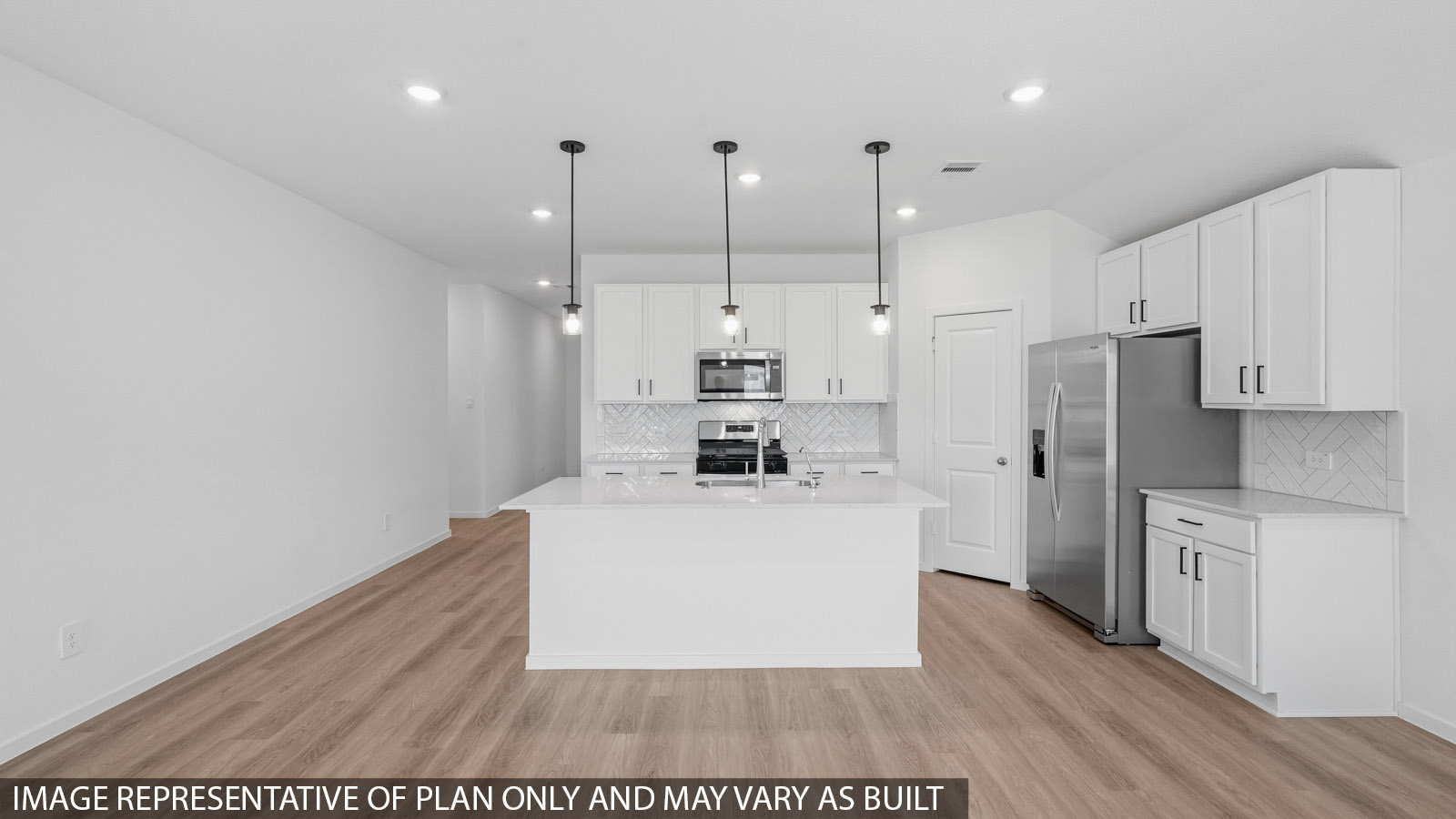Open kitchen with an island, stainless steel appliances, white cabinets, white walls, and vinyl wood flooring.