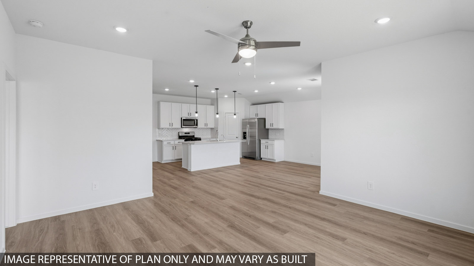 Open living room with white walls, windows, and vinyl wood flooring.