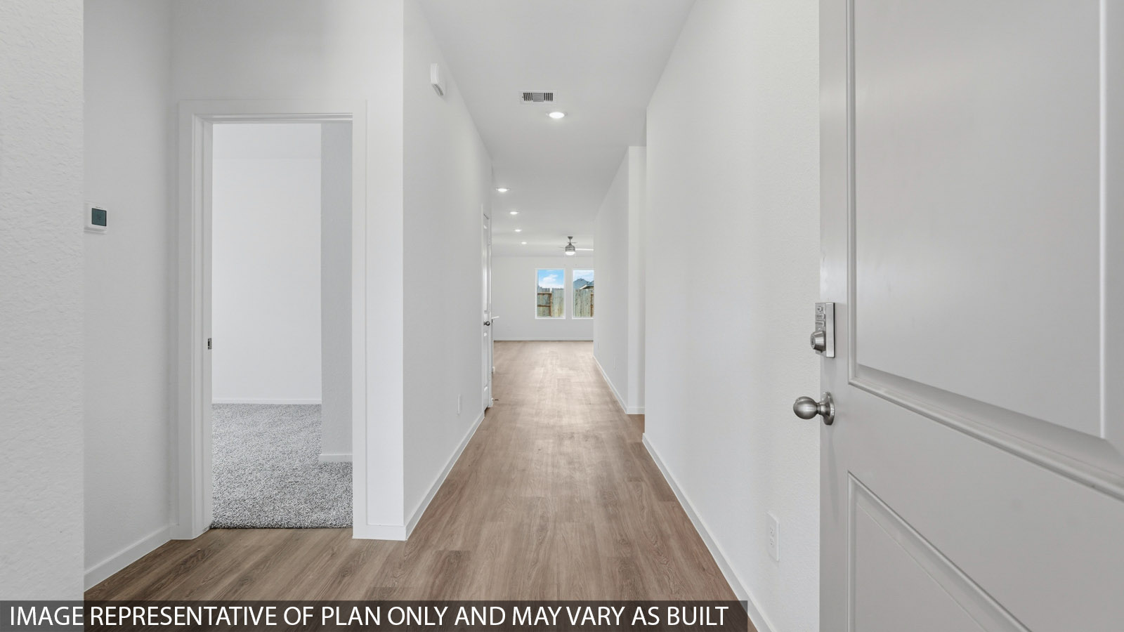 Entry hallway with vinyl wood flooring and white walls.