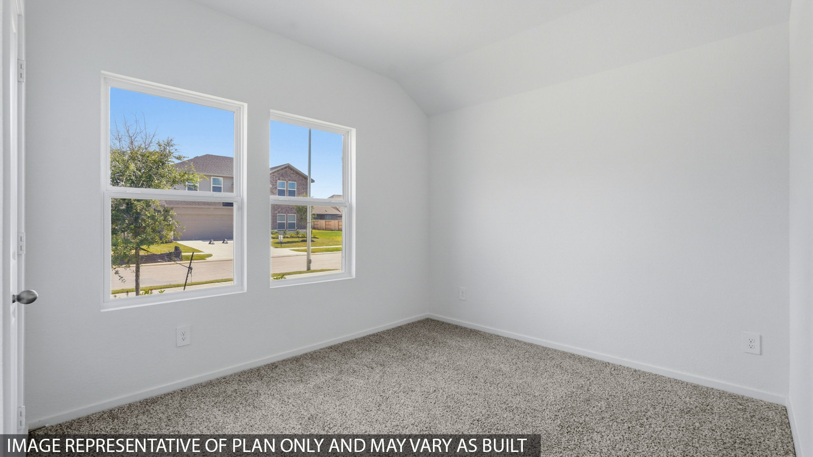 Secondary bedroom with white walls, windows, and light carpet.