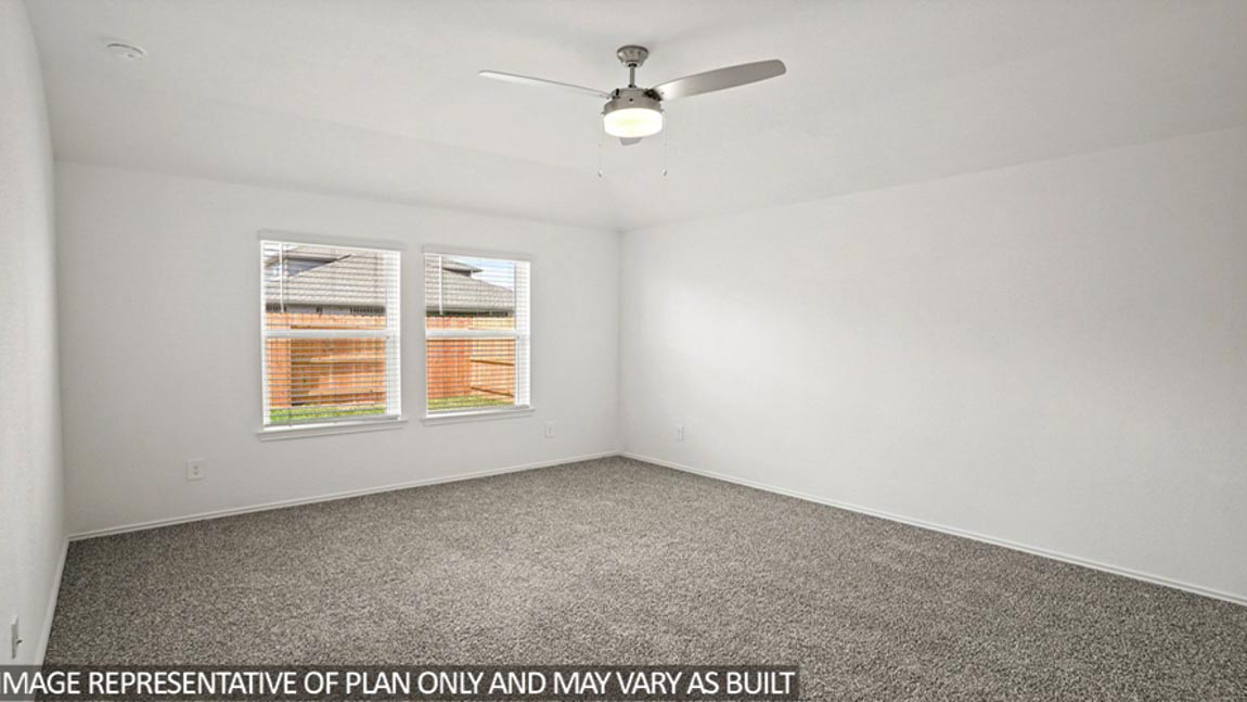 Primary bedroom with white walls, windows, and light carpet.