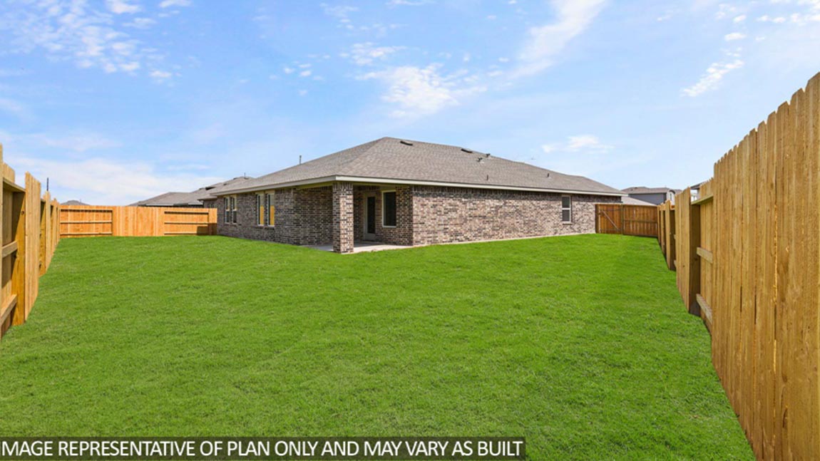 Landscaped backyard with a covered patio.