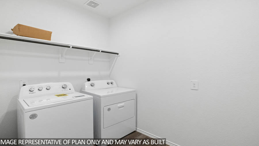 Laundry room with white walls and vinyl wood flooring.