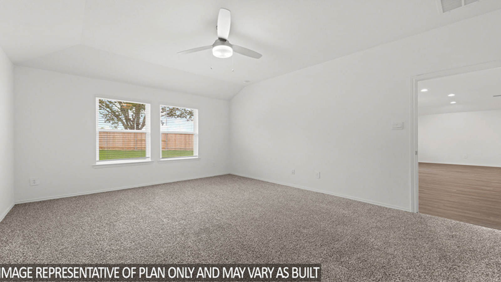 Primary bedroom with white walls, windows, and light carpet.