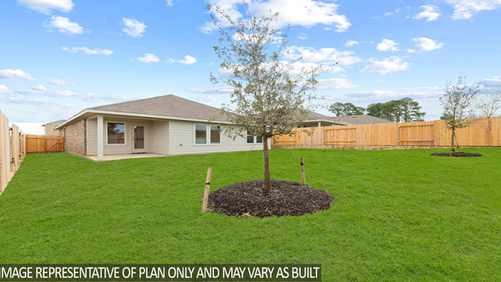Landscaped backyard with a covered patio.