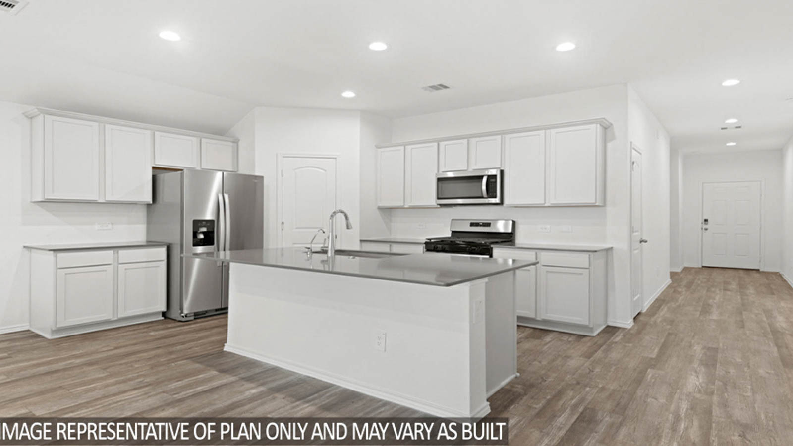 Open kitchen with an island, stainless steel appliances, white cabinets, white walls, and vinyl wood flooring.