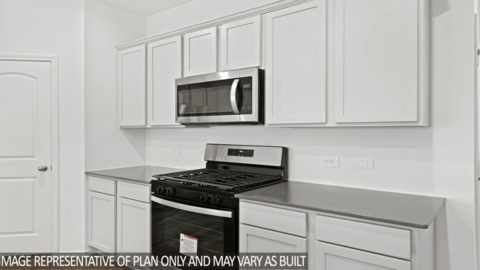 Open kitchen with an island, stainless steel appliances, white cabinets, white walls, and vinyl wood flooring.