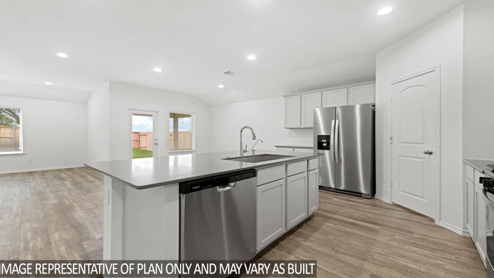Open kitchen with an island, stainless steel appliances, white cabinets, white walls, and vinyl wood flooring.