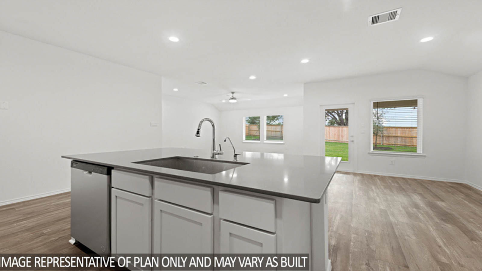 Open kitchen with an island, stainless steel appliances, white cabinets, white walls, and vinyl wood flooring.
