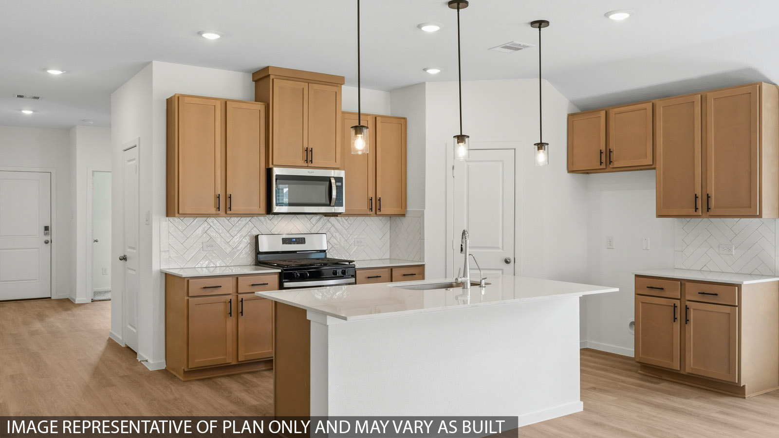 Open kitchen with an island, stainless steel appliances, white cabinets, white walls, and vinyl wood flooring.