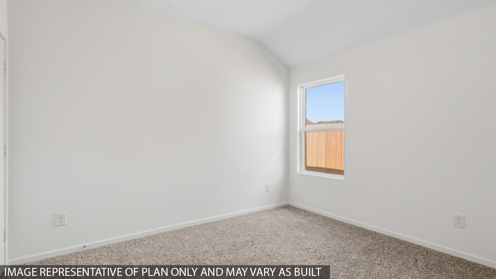 Secondary bedroom with white walls, windows, and light carpet.