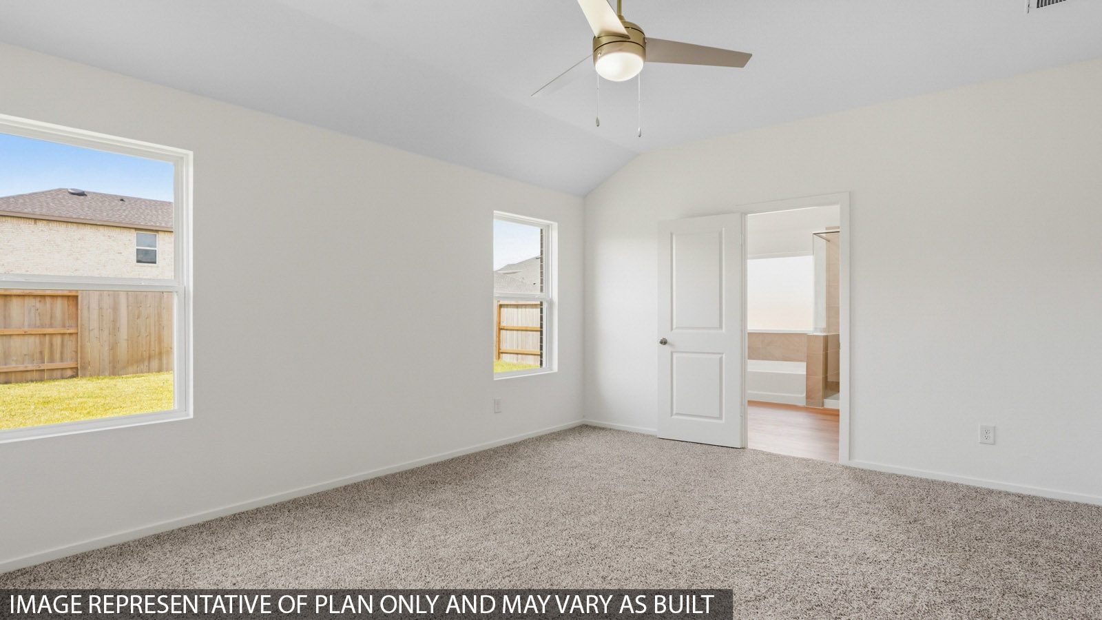 Primary bedroom with white walls, windows, and light carpet.