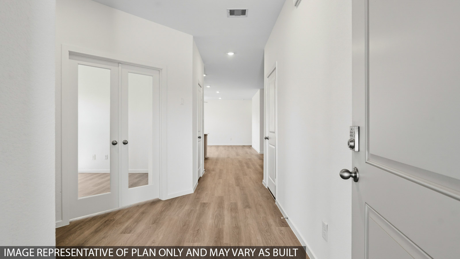 Entry hallway with vinyl wood flooring and white walls.